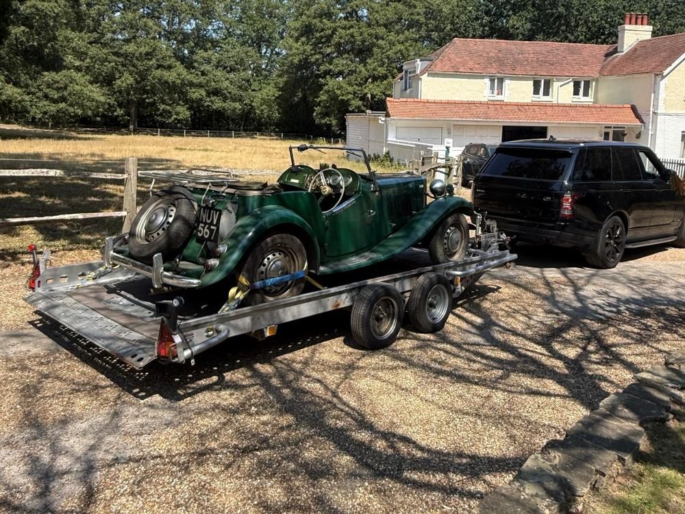 Classic MG sports car secured on a car trailer